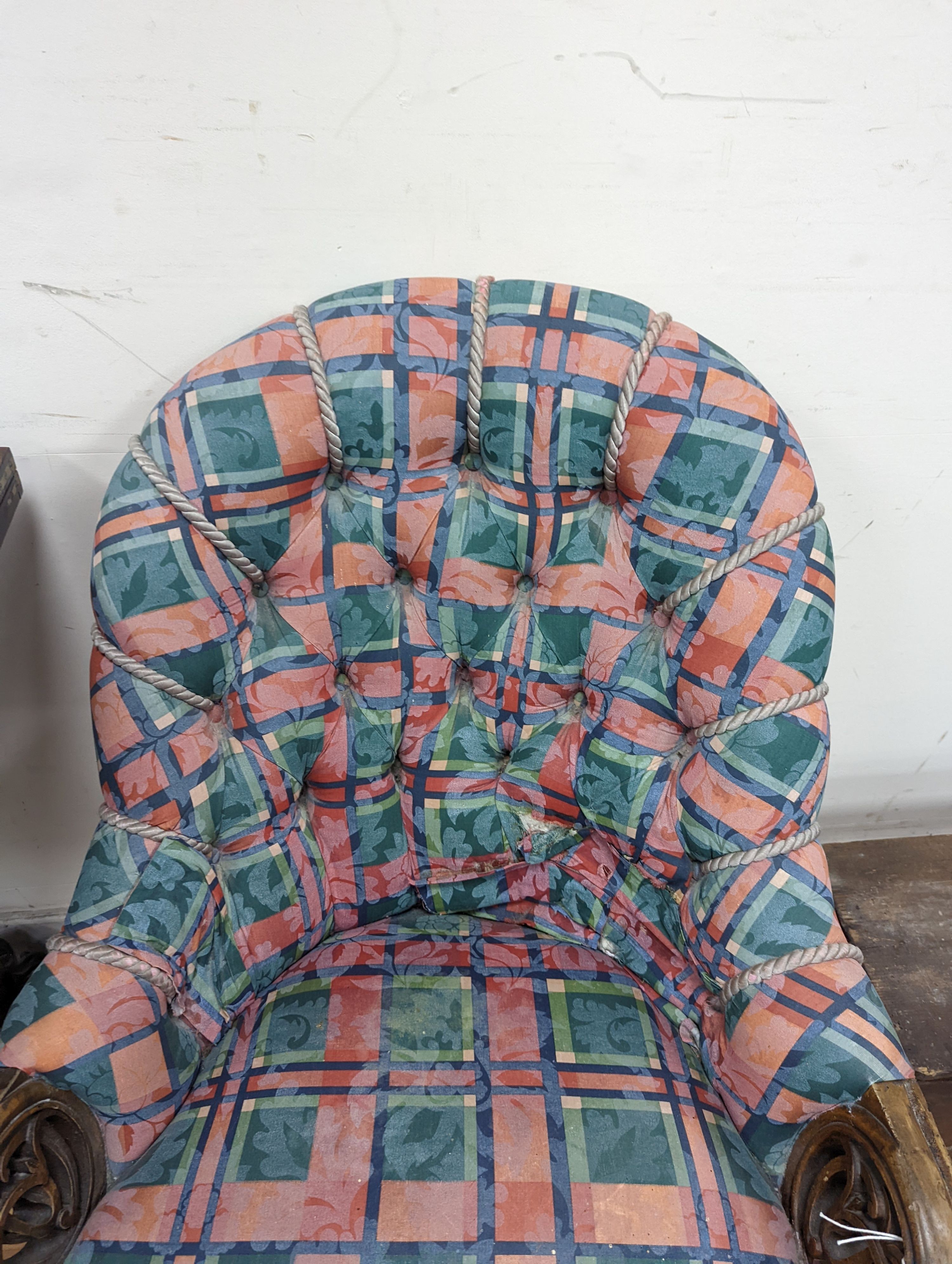 A Victorian carved walnut button back armchair
